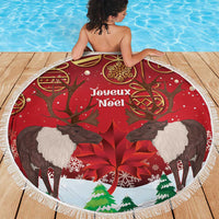 Red round beach blanket with caribou, maple leaf, and Joyeux Noel print