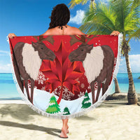 Round red beach blanket with caribou, maple leaf print, and fringe.