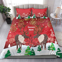 Red duvet cover and matching pillows with reindeer, pine trees, and snowflake pattern.