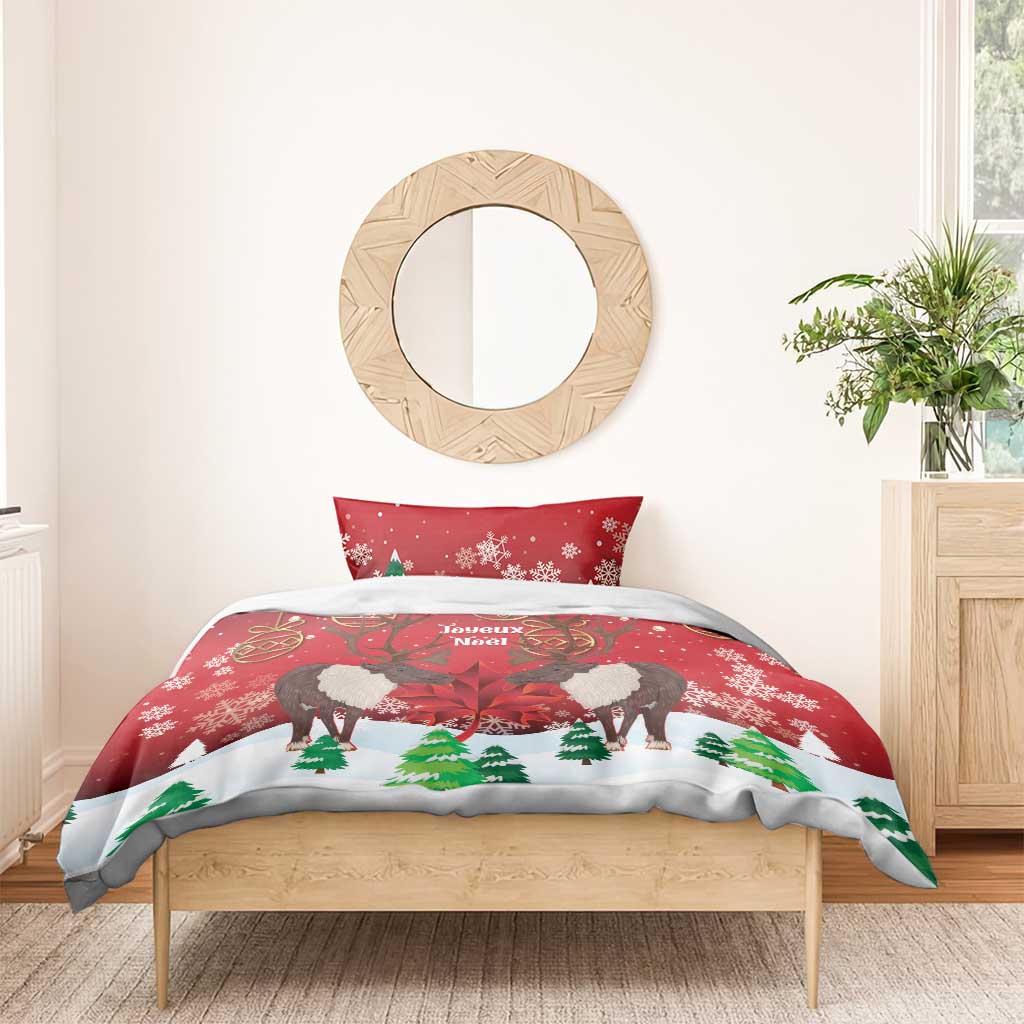 Christmas bedding set with red caribou and maple leaf print, shown on bed.