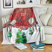 Christmas blanket with red and white scene, caribou, evergreen trees, and holiday text
