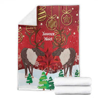 Red Christmas blanket with caribou, maple leaf and Joyeux Noël print