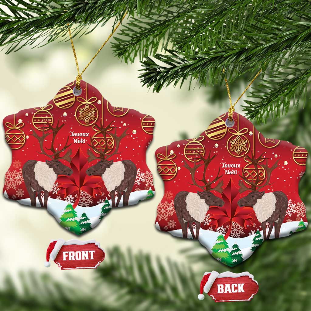 Red ceramic bell-shaped ornament with caribou scene, gold hanging loop, front/back labels