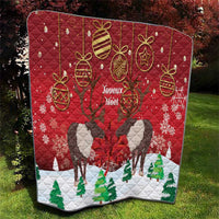 Red Christmas quilt blanket with caribou silhouettes, gold baubles, and 'Joyeux Noel' text