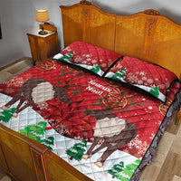 Red quilt bed set with caribou scene, green tree accents, snowflakes, and two pillows