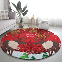 Red round Christmas rug with reindeer silhouettes, poinsettias, and Joyeux Noel wording