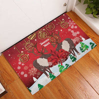 Red Christmas doormat in corner with caribou and 'Joyeux Noel' lettering, snowy ornament pattern