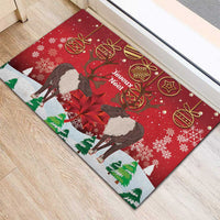 Red Christmas doormat angled view with caribou, 'Joyeux Noel' text, snowflakes and ornaments