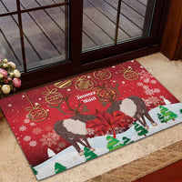 Red Christmas doormat featuring caribou and 'Joyeux Noel', framed by snowflakes and baubles