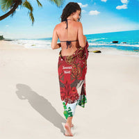 Red Christmas sarong with caribou scene, snowflakes, and maple-leaf emblem print