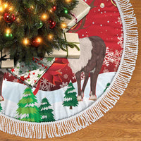 Round red tree skirt showing reindeer and green trees, white braided fringe trim