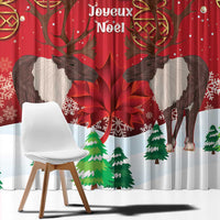 Red Christmas window curtain close-up with two reindeer and Joyeux Noel text above trees.