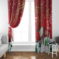 Red Christmas curtain panels beside a door, with reindeer, gold ornaments, and snowflake print.