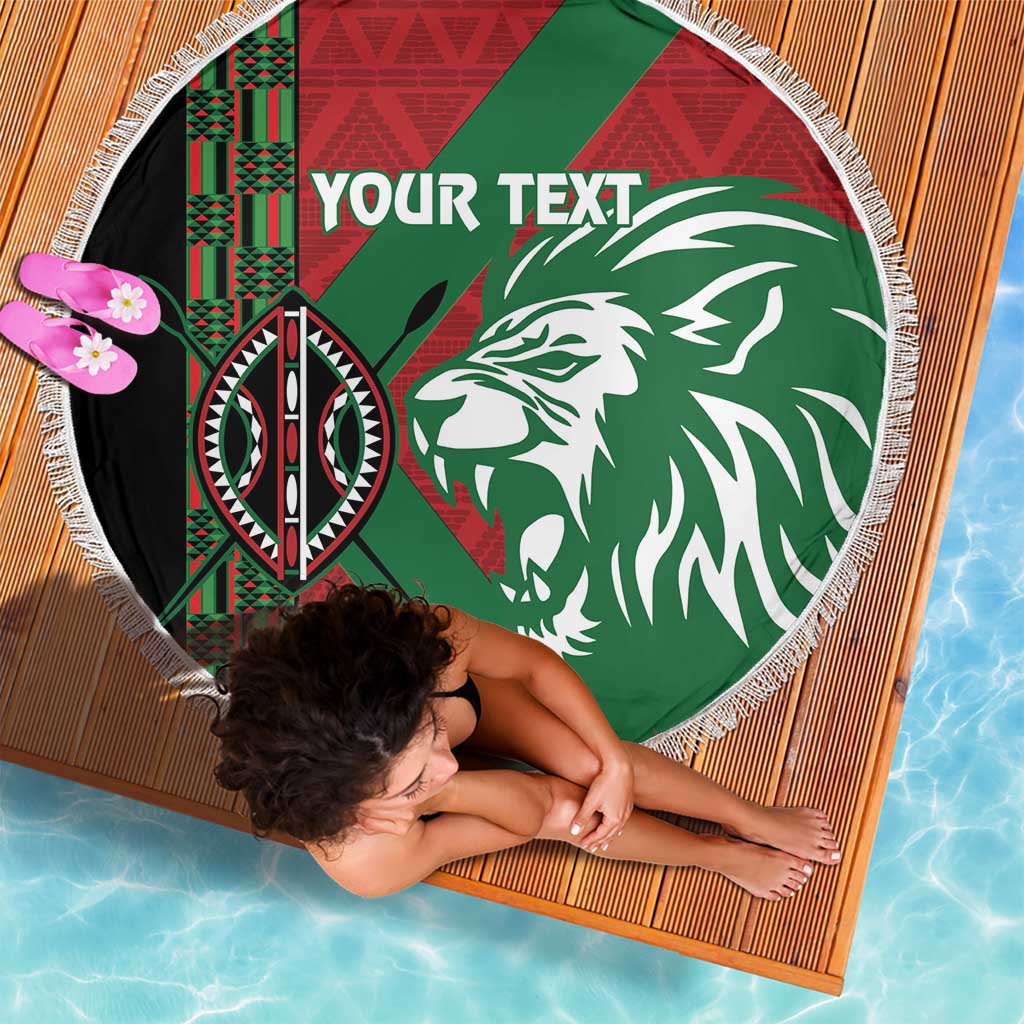 Round fringe-edged beach blanket, green-red lion graphic with “YOUR TEXT”, angled view