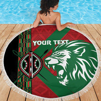 Round fringe-edged beach blanket on deck, green-red lion graphic with “YOUR TEXT”