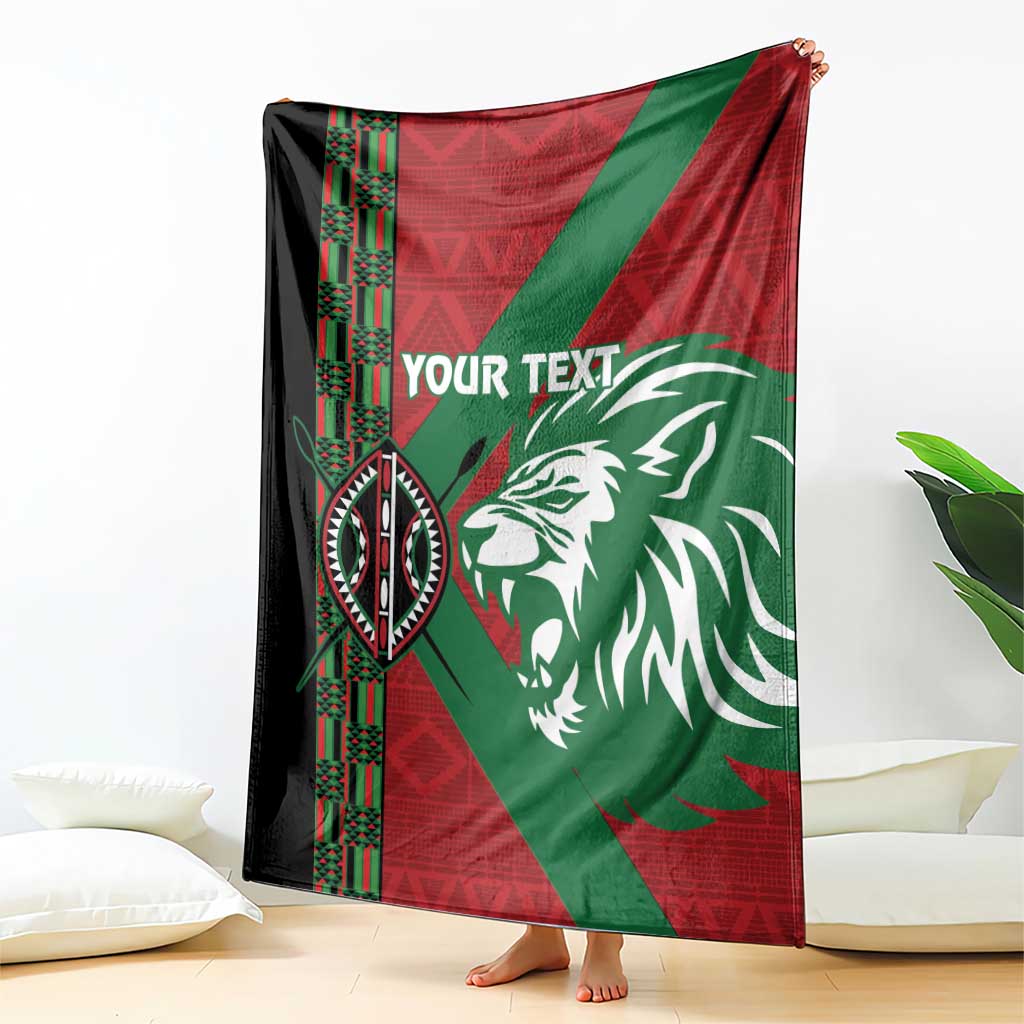 Custom blanket draped indoors with red and green panels, lion graphic, and “YOUR TEXT”