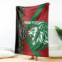 Custom blanket draped indoors with red and green panels, lion graphic, and “YOUR TEXT”