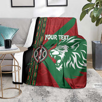 Custom blanket on chair side table area featuring lion design and red-green African pattern