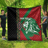 Red, green and black Africa-style quilt with lion emblem, vertical patterned trim, diamond quilting