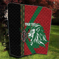 Red and green quilt with white lion graphic, black side panel, diamond quilt stitching