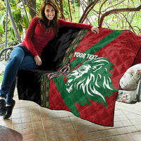 Red and green quilt with white lion graphic, black side panel, diamond quilt texture