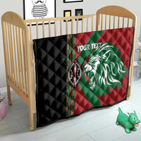 Red, green and black quilt with white lion graphic and patterned border, quilted diamond texture