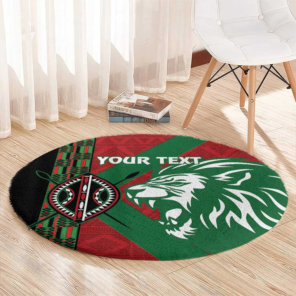 Round green, red and black rug featuring lion head graphic and tribal pattern
