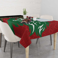 Red and green patterned tablecloth with large lion silhouette on dining table