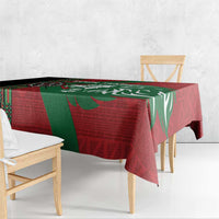 Red and green tablecloth with geometric border and lion illustration, draped on table