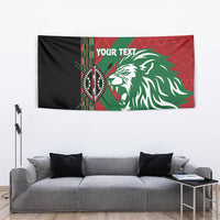 Custom tapestry showing black side panel, red geometric background, green banner stripe, lion head, "YOUR TEXT".