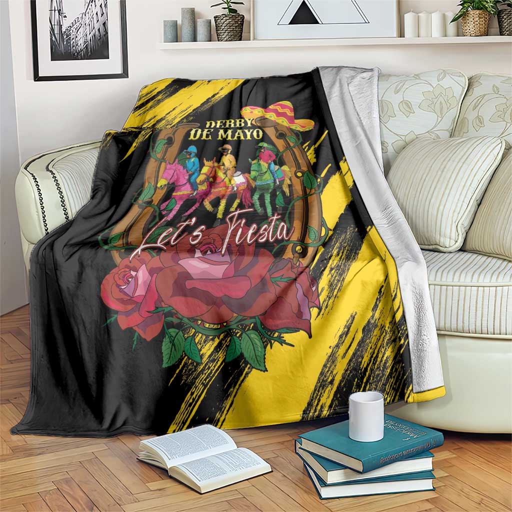 Black and yellow horse racing blanket draped over a couch, “Derby De Mayo” design.
