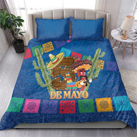 Blue bedding set with two pillows, 'DE MAYO' artwork, sombrero figures and colorful squares