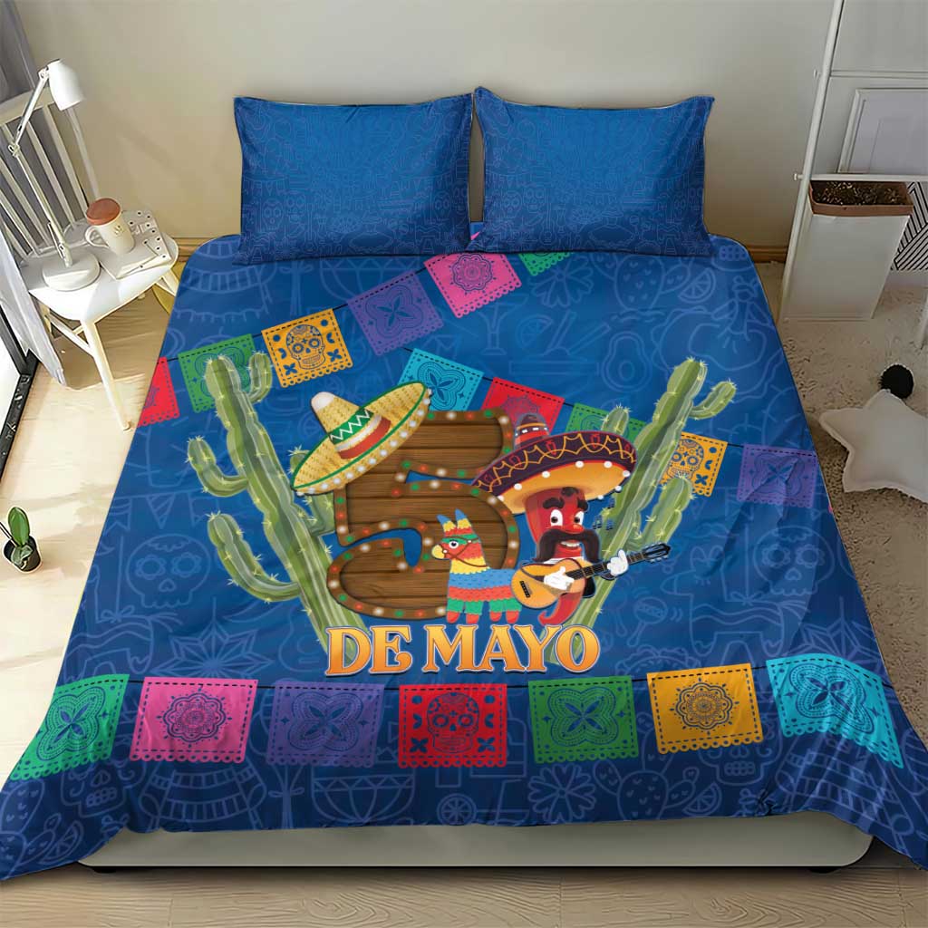 Blue bedding set with two pillows, 'DE MAYO' artwork with cacti, sombrero figures and squares