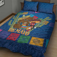 Blue quilt bed set with 'DE MAYO' cowboy scene, cactus, and multicolor square motifs on bed
