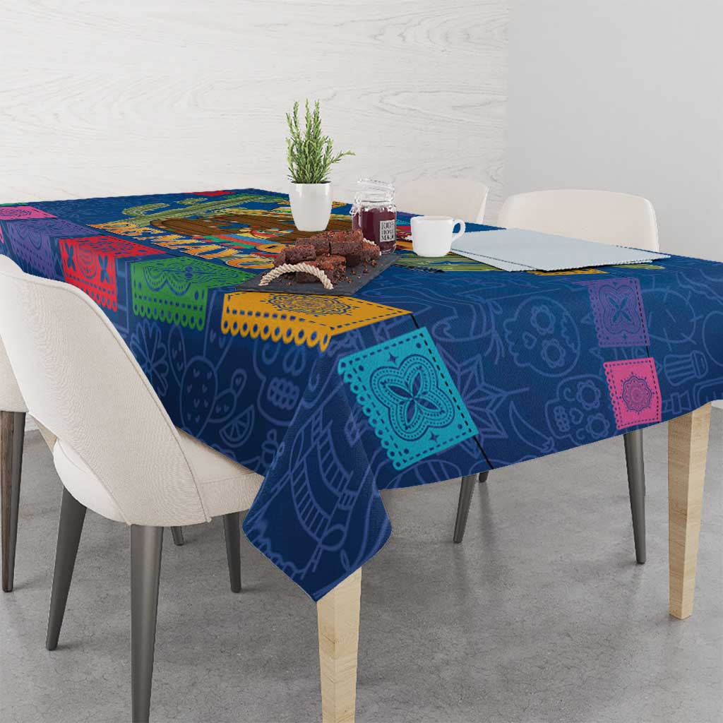 Blue tablecloth draped over dining table with colorful square trim