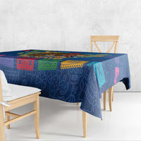 Blue tablecloth covering dining table with multicolor patterned band