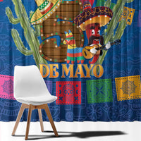 Close-up of blue window curtain showing “DE MAYO” text, cactus, and guitar player.