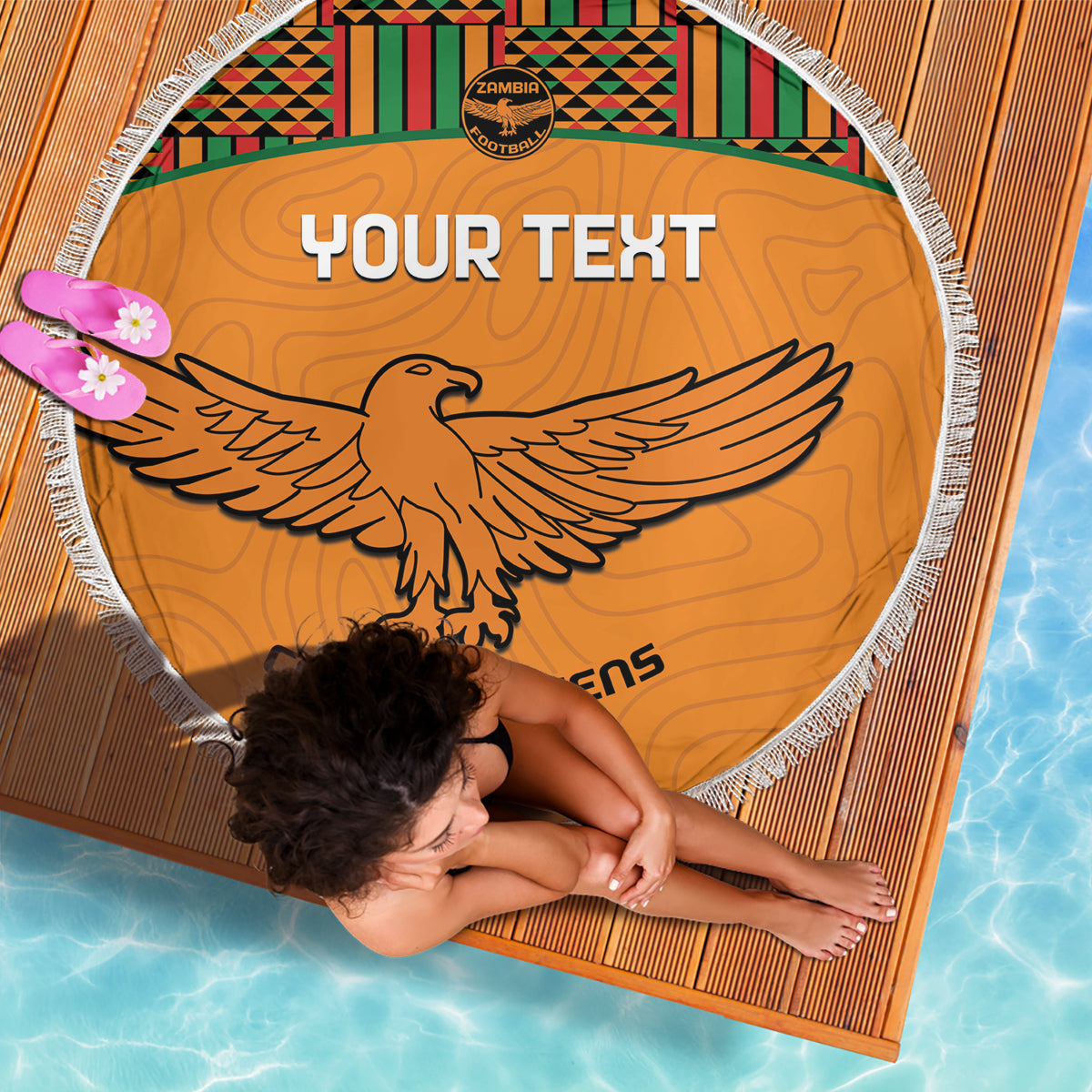 Orange round beach blanket with fringe, Kente strip band and large eagle emblem