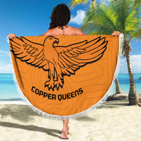 Orange round beach blanket with white fringe, eagle emblem and 'COPPER QUEENS' text