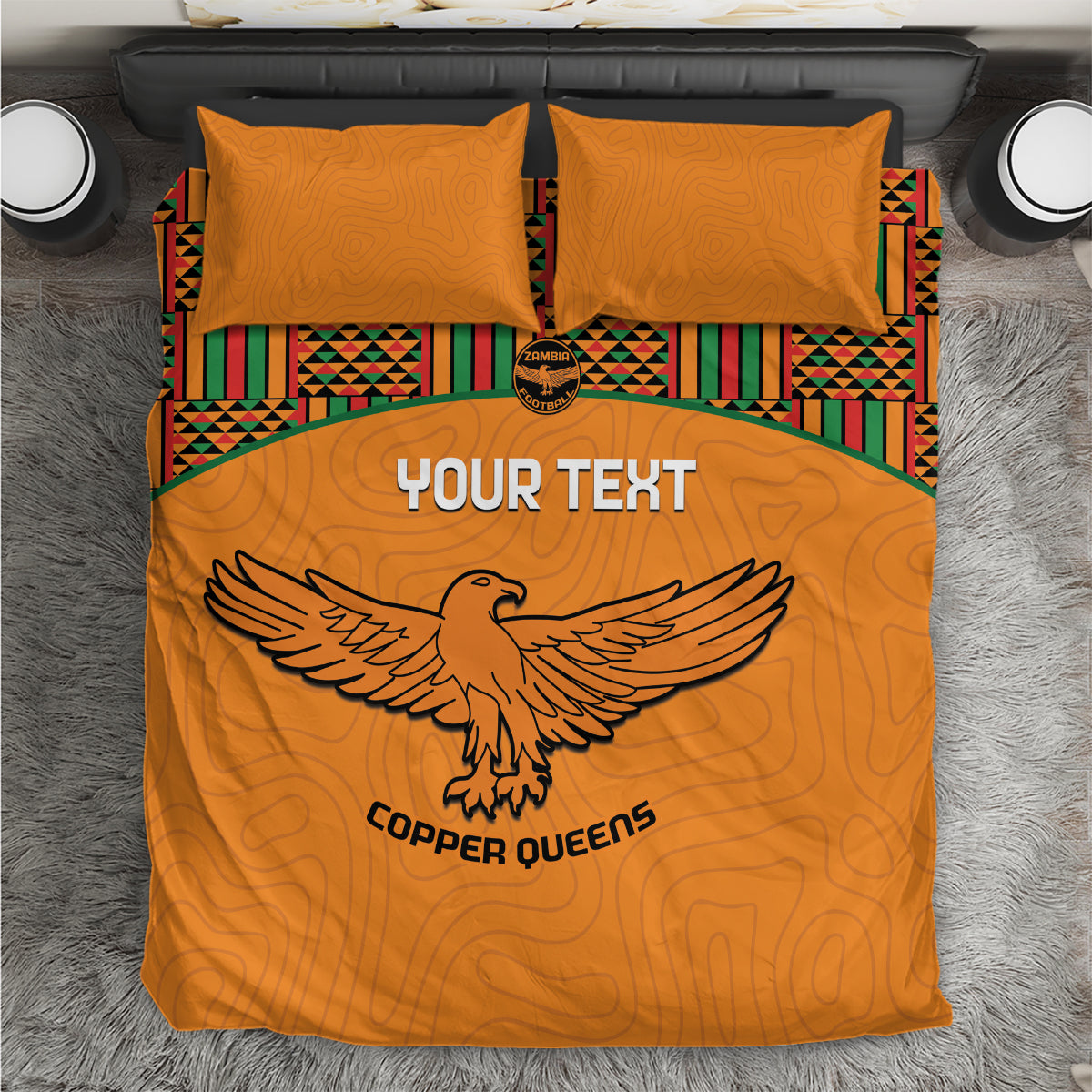 Orange football bedding set with two pillows, Kente stripes, and bird emblem graphic