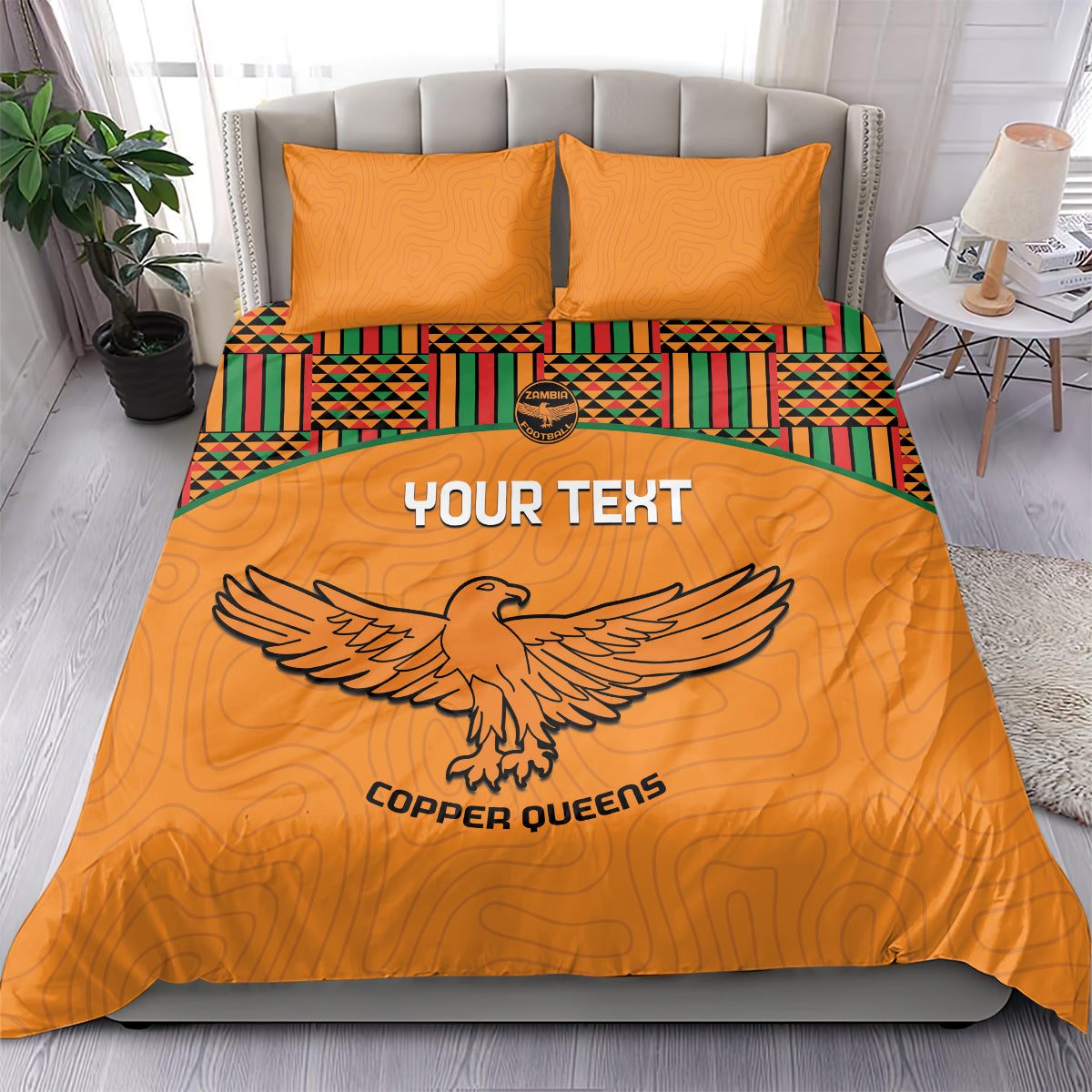 Orange duvet and two pillows with Kente panel border and large bird emblem center