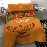 Orange bedding set with two pillows, Kente-striped bands, and bold bird emblem design