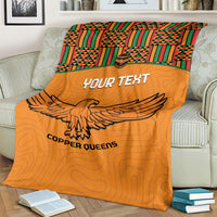 Orange football blanket on beige sofa with Kente panel, eagle graphic, and Custom text