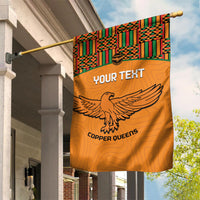 Orange hanging garden flag with Kente geometric top band, eagle graphic, and Copper Queens