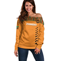 Orange off-shoulder football sweater with Kente trim, 'ZAMBIA' front graphic