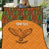 Orange quilted blanket with multicolor Kente border and eagle graphic, Copper Queens