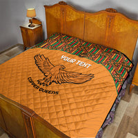 Orange quilted blanket with Kente-pattern border and eagle graphic, Copper Queens