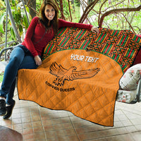 Orange quilt blanket with quilted diamond stitching, Kente border, eagle emblem