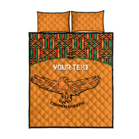 Orange quilt bed set with Kente-style patterned center, eagle emblem, two matching pillows