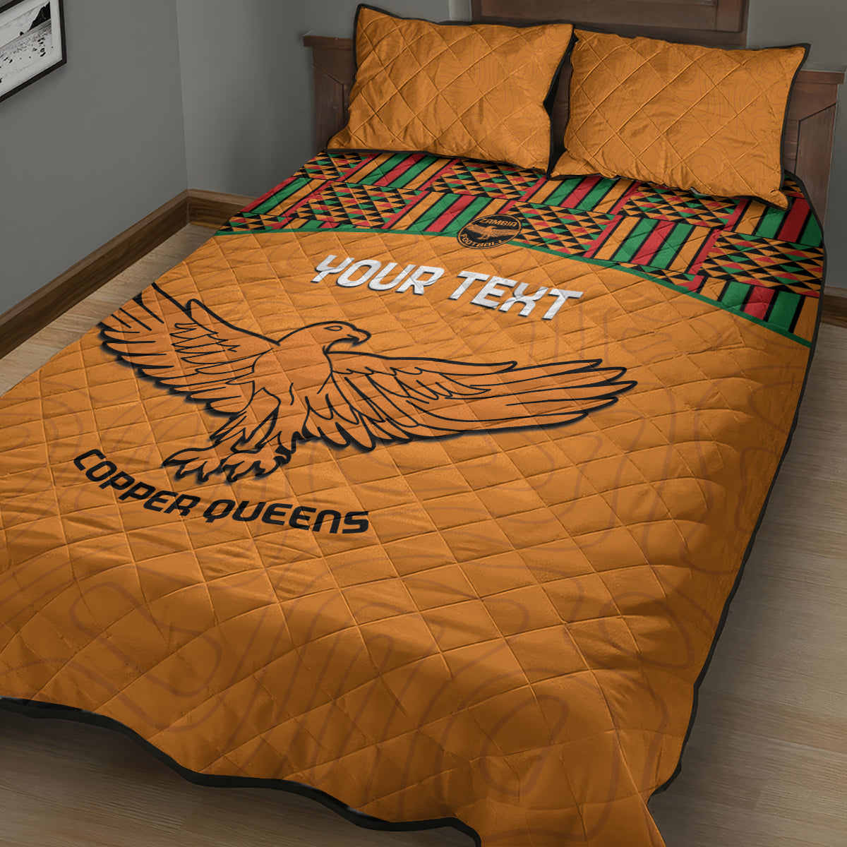 Orange football quilt bed set with large eagle print and Kente stripe border, two pillows